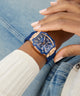 Woman wearing a blue and rose gold watch on a denim background GW0945L4