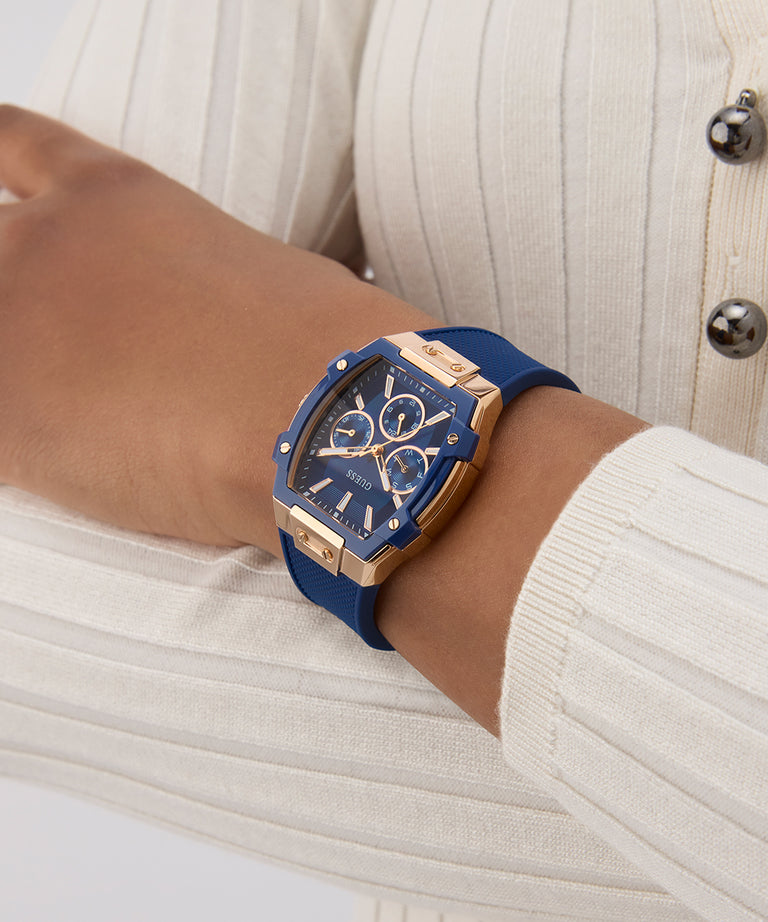 Blue watch with gold accents on a wrist against a neutral background GW0945L4