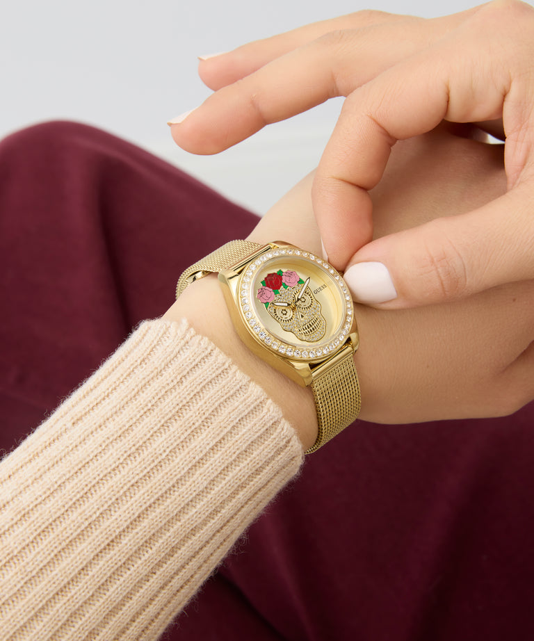 Limited Edition Day Of The Dead watch with a decorative face on a wrist, wearing a beige sleeve.