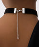 Black choker with a silver chain and 'G' pendant on a neutral background