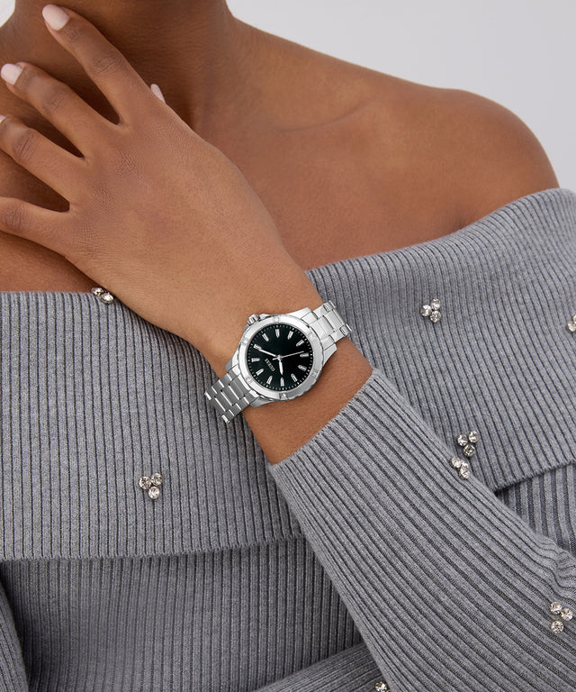 GUESS Ladies Silver Tone Analog Watch on a wrist with a gray sweater