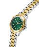 GUESS Ladies 2-Tone Analog Watch with green dial on a white background lifestyle