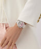 Hand wearing a silver watch with a pink face, dressed in a white outfit. GW0950L1