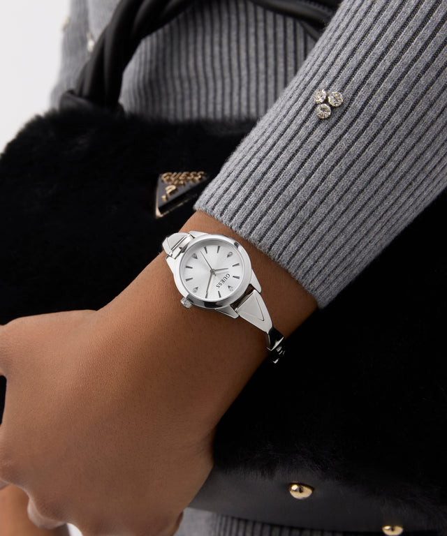 Silver watch on a wrist with a blurred background