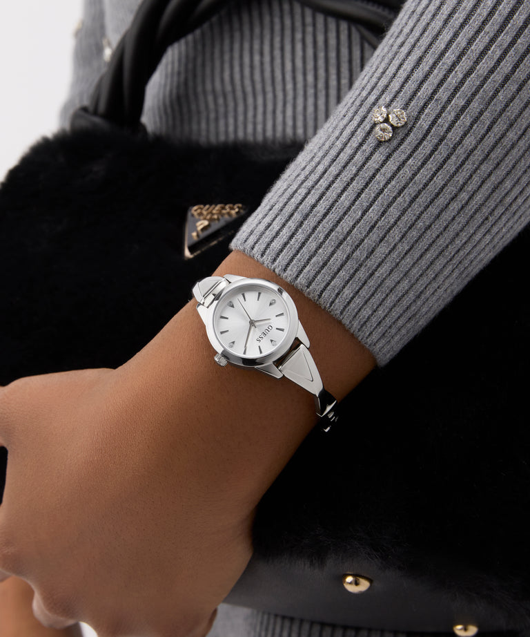 Silver watch on a wrist with a blurred background