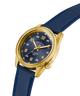 GUESS Mens Blue Gold Tone Analog Watch with blue strap and gold case on a white background lifestyle