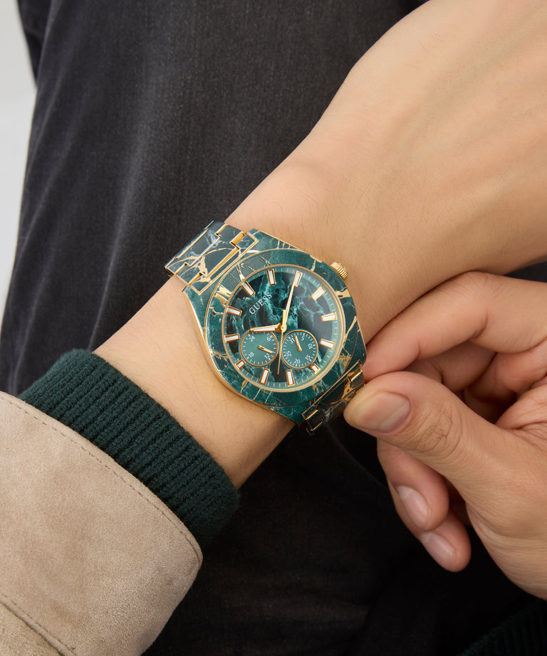 Close-up of a wrist wearing a decorative watch with a detailed band.
