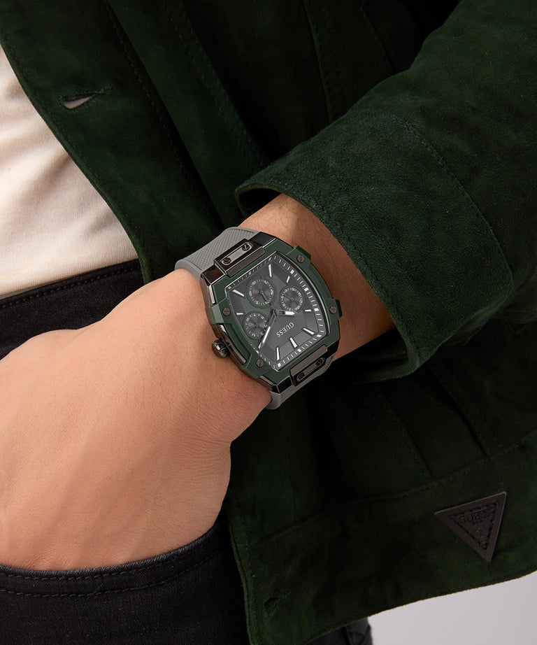 Person wearing a dark green jacket with a watch on their wrist