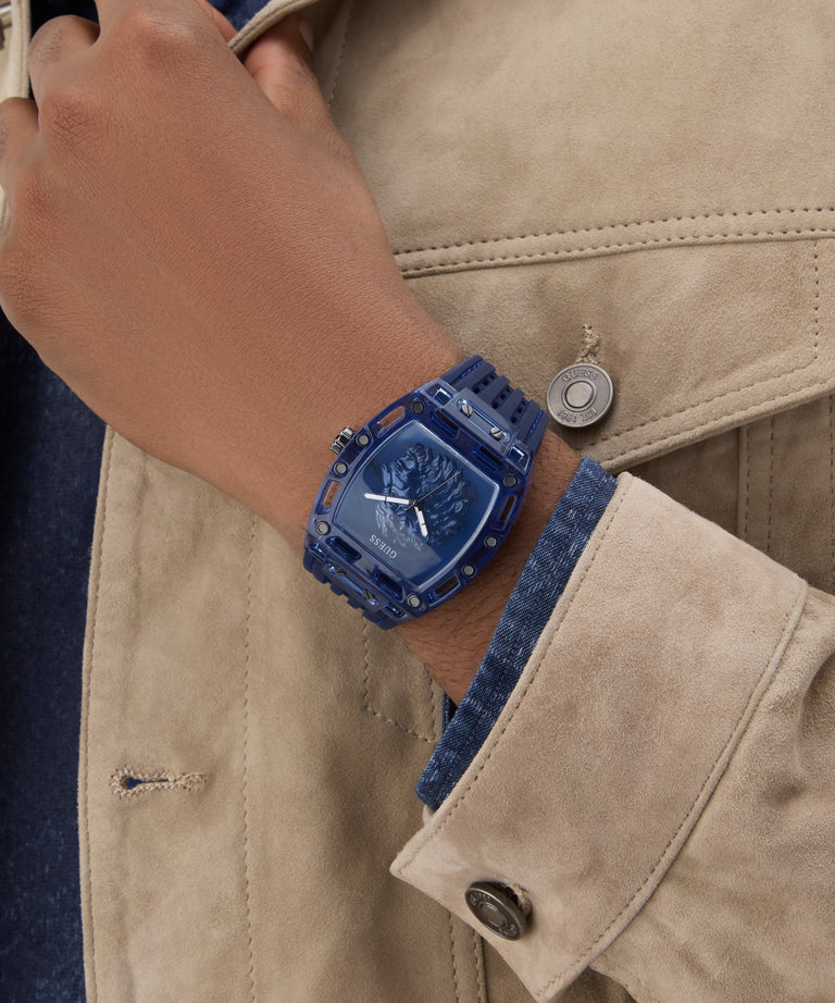 GUESS Mens Blue Analog Watch Blue watch on a wrist with a beige jacket
