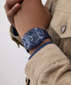 GUESS Mens Blue Analog Watch Blue watch on a wrist with a neutral background