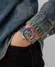 Person wearing a colorful Limited Edition Day Of The Dead watch with a denim jacket on a gray background