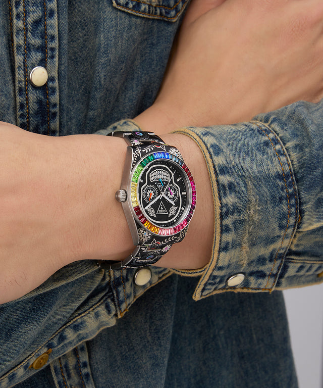 Wrist wearing a colorful Limited Edition Day Of The Dead watch with a denim jacket