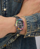 Wrist wearing a colorful Limited Edition Day Of The Dead watch with a denim jacket