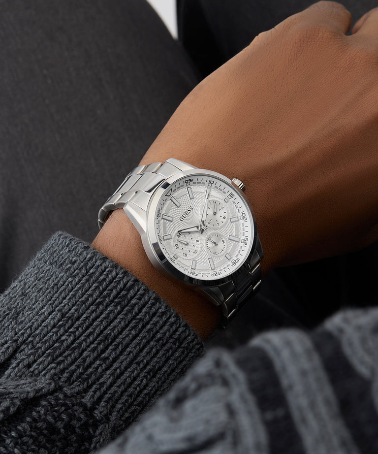 GUESS Mens Silver Tone Multi-function Watch on a person's wrist with a dark background