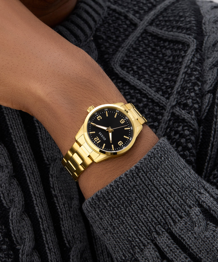 Gold watch on a wrist with a dark sweater background GW0965G2