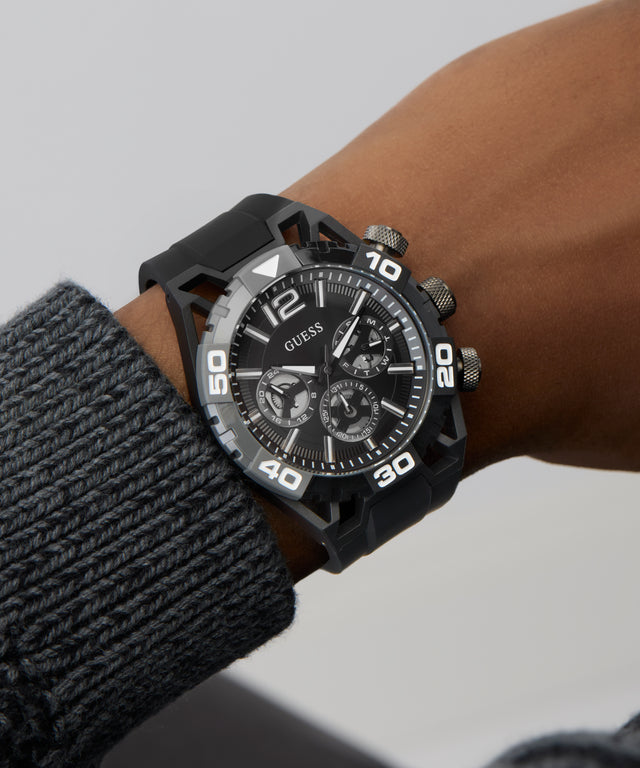 GUESS Mens Black Multi-function Watch on a wrist with a gray background