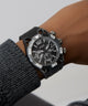 GUESS Mens Black Multi-function Watch on a wrist with a gray background
