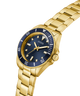 Gold watch with a blue face on a white background lifestyle