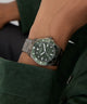 GUESS Mens Gunmetal Analog Watch on a person's wrist with a dark background