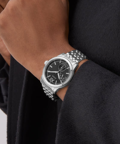 Silver GUESS Mens Silver Tone Multi-function Watch on a wrist with a black background