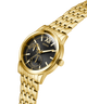 Gold watch with a black face on a white background lifestyle