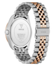 Guess watch caseback
with two-tone metal band on a white background