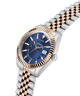 Two-tone watch with blue dial and rose gold accents on a white background lifestyle