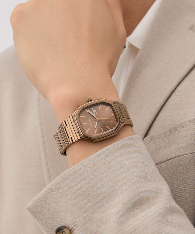 GUESS Mens Coffee Date Watch on a wrist with a neutral background