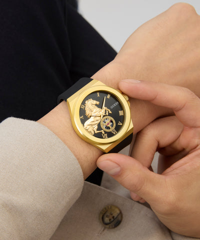 Gold GUESS Mens Limited Edition Lunar New Year Black Gold Tone Analog Watch with black face on a wrist, close-up view