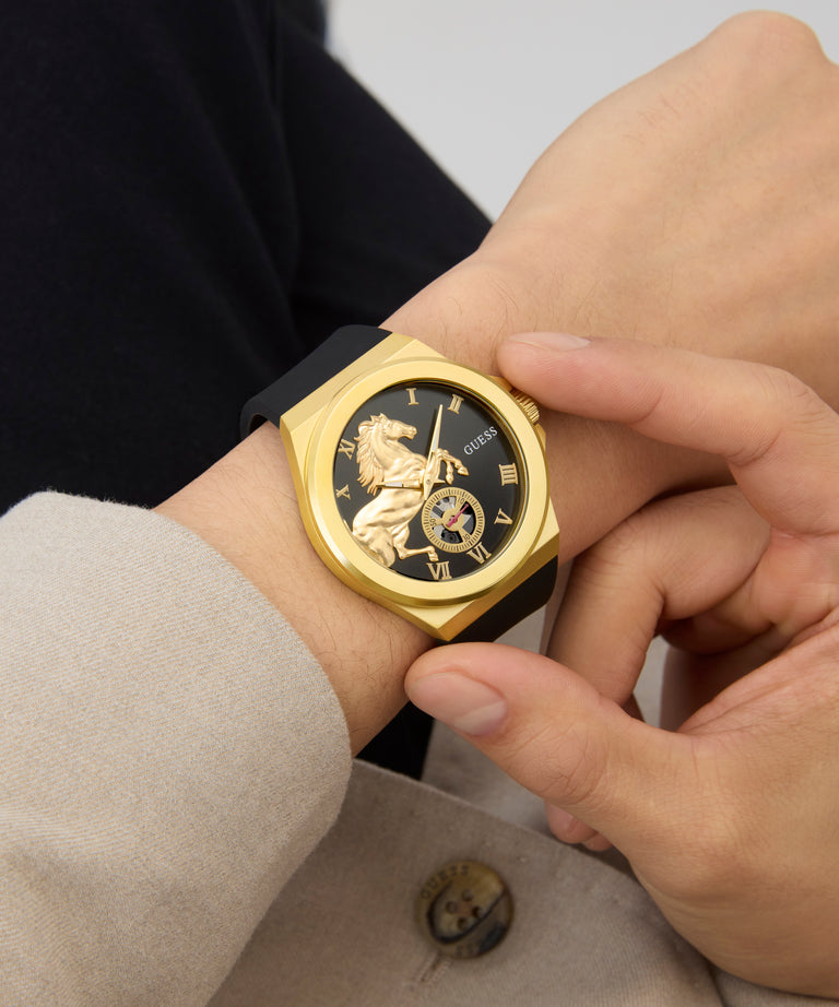 Gold GUESS Mens Limited Edition Lunar New Year Black Gold Tone Analog Watch with black face on a wrist, close-up view