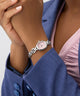 GUESS Ladies Silver Tone Analog Watch on a wrist with a person wearing a blue jacket.