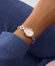 GUESS Ladies Silver Tone Analog Watch on a wrist with a blue sleeve