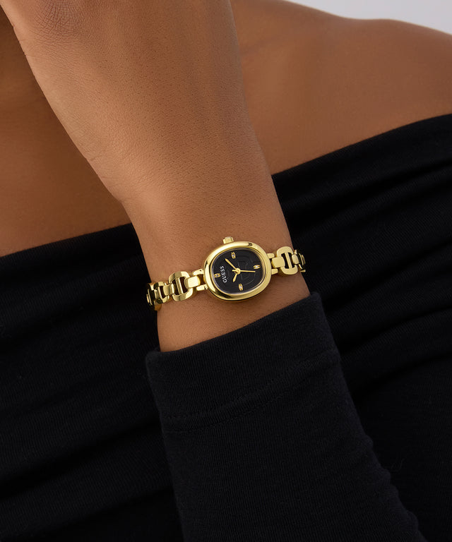 GUESS Ladies Gold Tone Analog Watch on a wrist with a black background