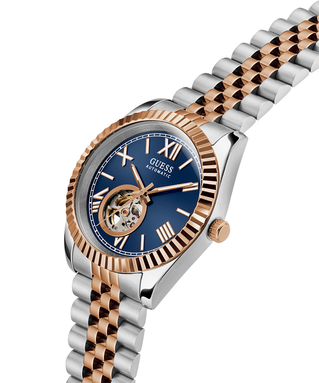 Two-tone Guess watch with blue dial and rose gold accents on a white background lifestyle