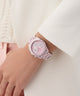GUESS Ladies Pink Multi-function Watch on a wrist with a light background