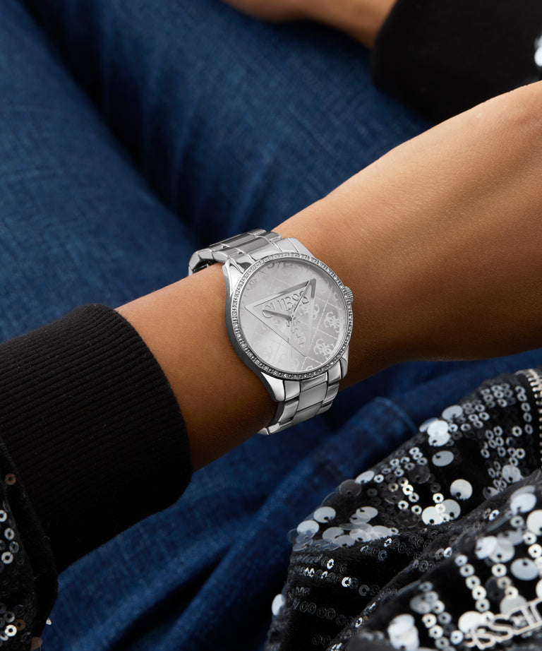 GUESS Ladies Silver Tone Analog Watch on a wrist with a dark background