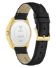 Black GUESS Ladies Black Gold Tone Analog Watch with gold case and black leather strap on a white background