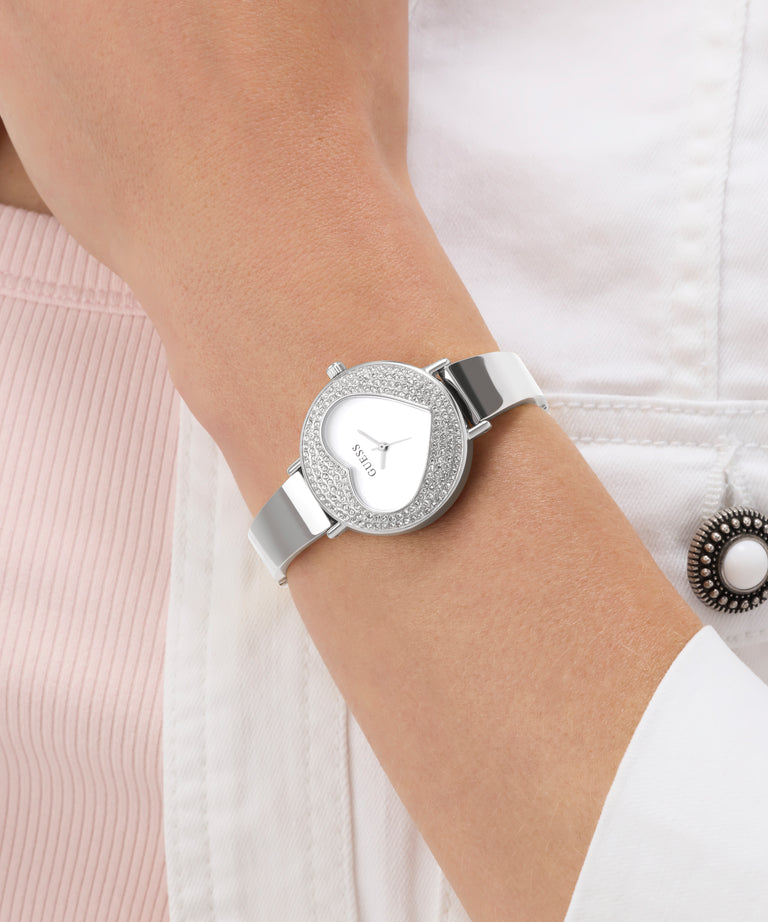 GUESS Ladies Silver Tone Analog Watch with gemstone accents on a wrist against a white background