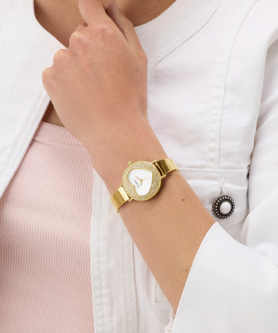 GUESS Ladies Gold Tone Analog Watch on a person's wrist with a white background