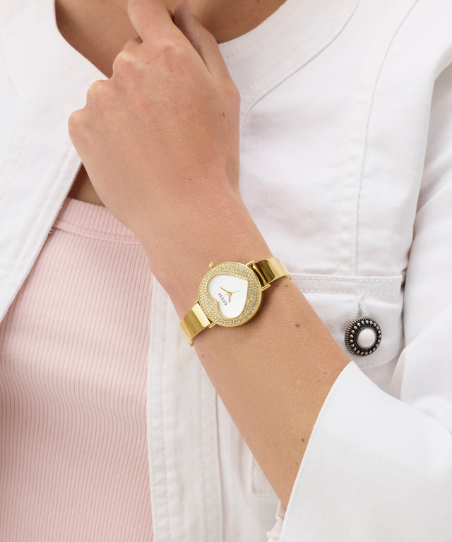 GUESS Ladies Gold Tone Analog Watch on a person's wrist with a white background
