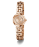 GUESS Ladies Rose Gold Tone Analog Watch with diamond-studded face on a white background