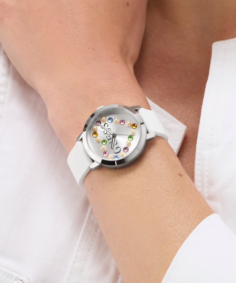 GUESS Ladies White Silver Tone Analog Watch with colorful gemstones on a wrist against a white background