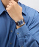 Person wearing a GUESS Mens BROWN SILVER TONE Analog Watch with a blue shirt