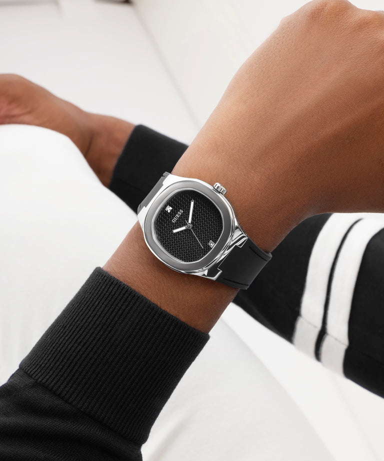 Close-up of a wrist wearing a black watch with a white background