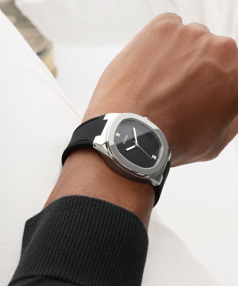 Close-up of a wrist wearing a black watch with a white background