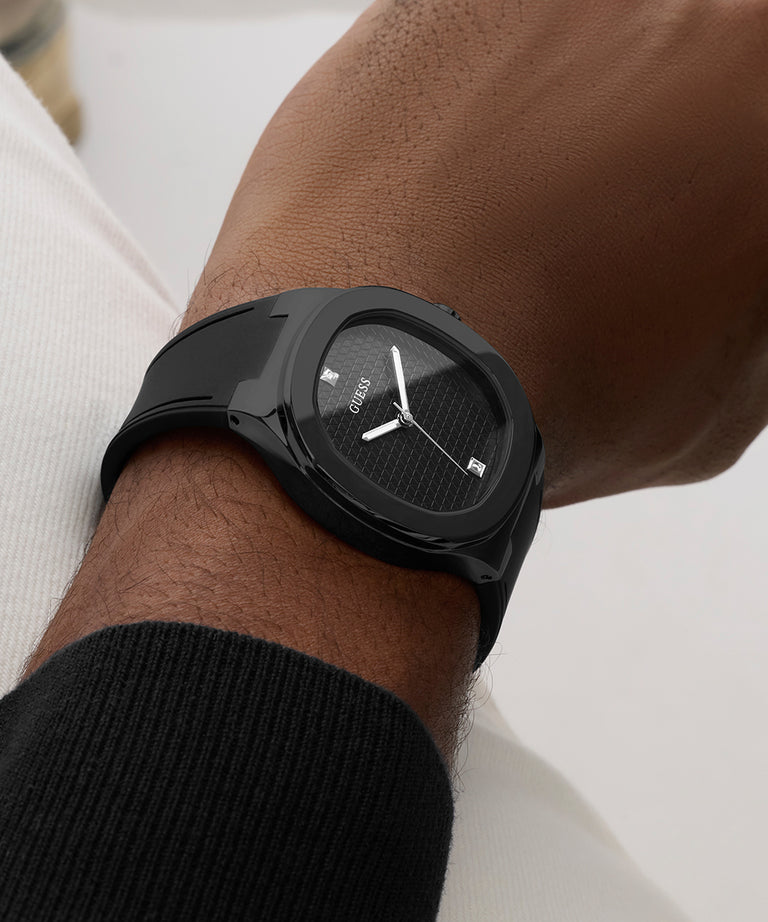 Black GUESS Mens BLACK Analog Watch on a person's wrist with a white background