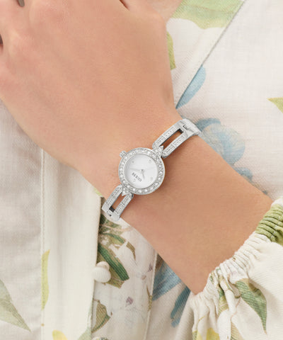 Silver GUESS Ladies Silver Tone Analog Watch with a floral-patterned background