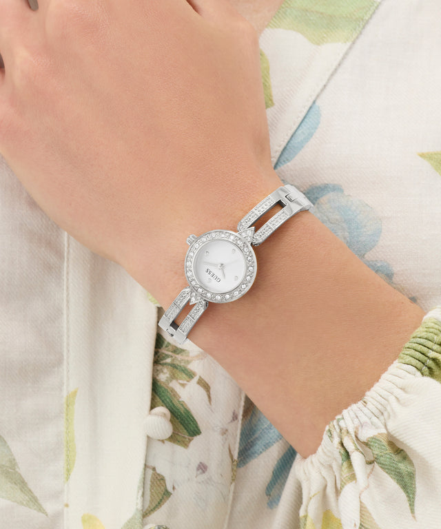 Silver GUESS Ladies Silver Tone Analog Watch with a floral-patterned background