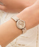 GUESS Ladies Rose Gold Tone Analog Watch on a wrist