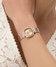 Rose gold watch on a wrist with a white lace garment